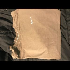 Tan Nike shirt.